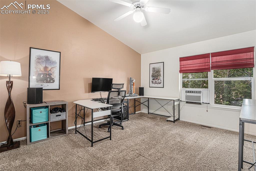 Image 14 of 22: Loft/office/multiple use area featuring light carpet, vaulted ceiling, and