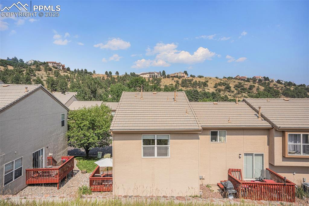 Image 19 of 22: Back of property with a deck on the left with mountain view