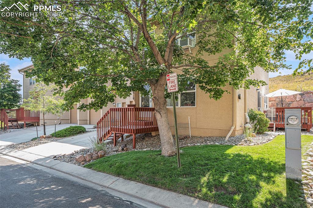 Image 3 of 22: Angled view of property featuring stucco siding and a front yard