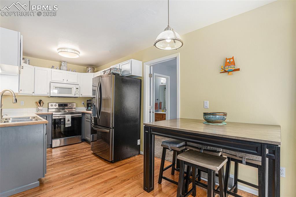 Image 9 of 22: Dining area off kitchen - beautiful hardwood flooring