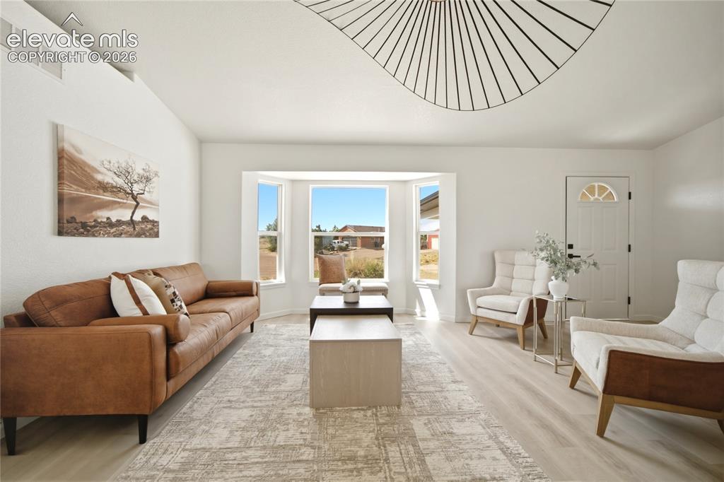 Image 11 of 40: Living room featuring light wood-finish flooring and white painted walls