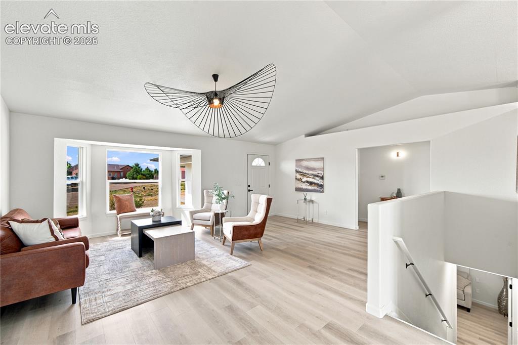 Image 3 of 40: Living area featuring light wood-finish flooring, a contemporary ceiling fi
