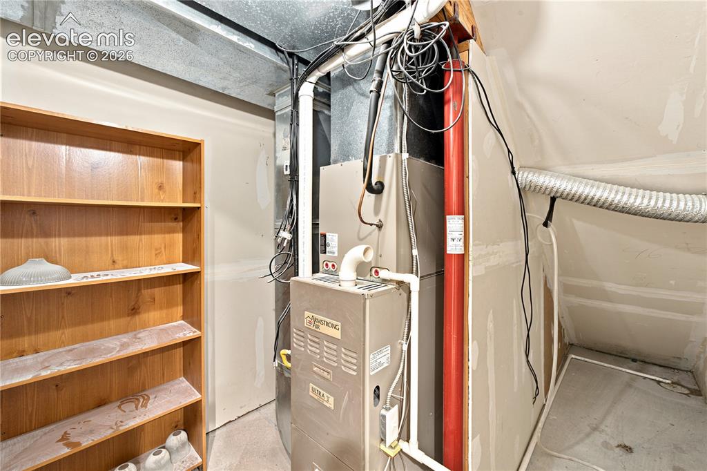 Image 31 of 40: Utility room featuring a furnace unit, exposed ductwork, flexible ventilati