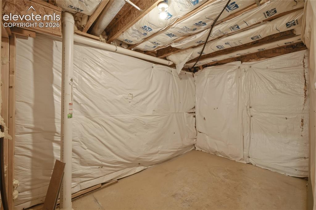 Image 33 of 40: Unfinished basement space featuring exposed wood joists and subflooring, wh