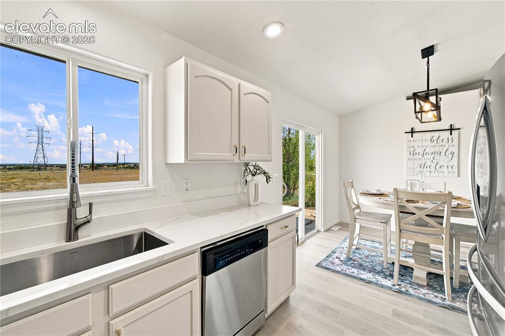 Image 6 of 40: Kitchen featuring a stainless steel undermount sink, a pull-down faucet, a 