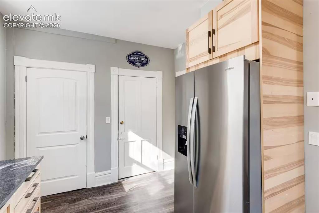 Image 11 of 27: Access to laundry and 1/2 bath off of kitchen.