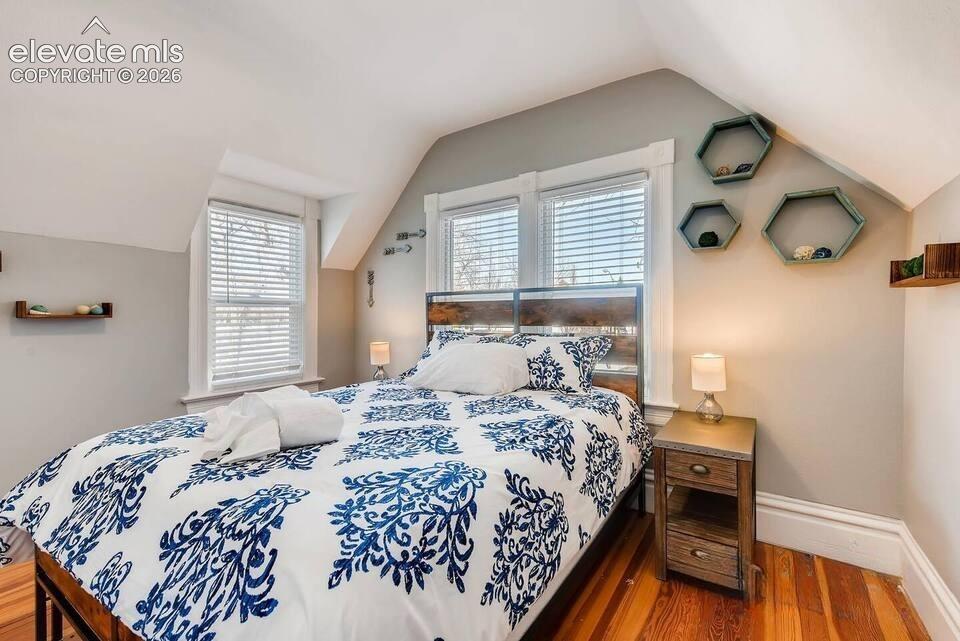 Image 20 of 27: Second floor bedroom overlooks Bijou Street. Original wood floors, dormer w