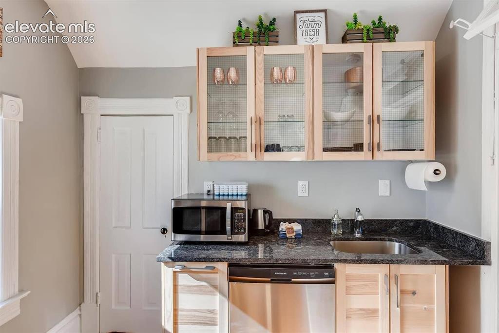Image 21 of 27: Second floor full kitchen with dishwasher, range and refrigerator with smal