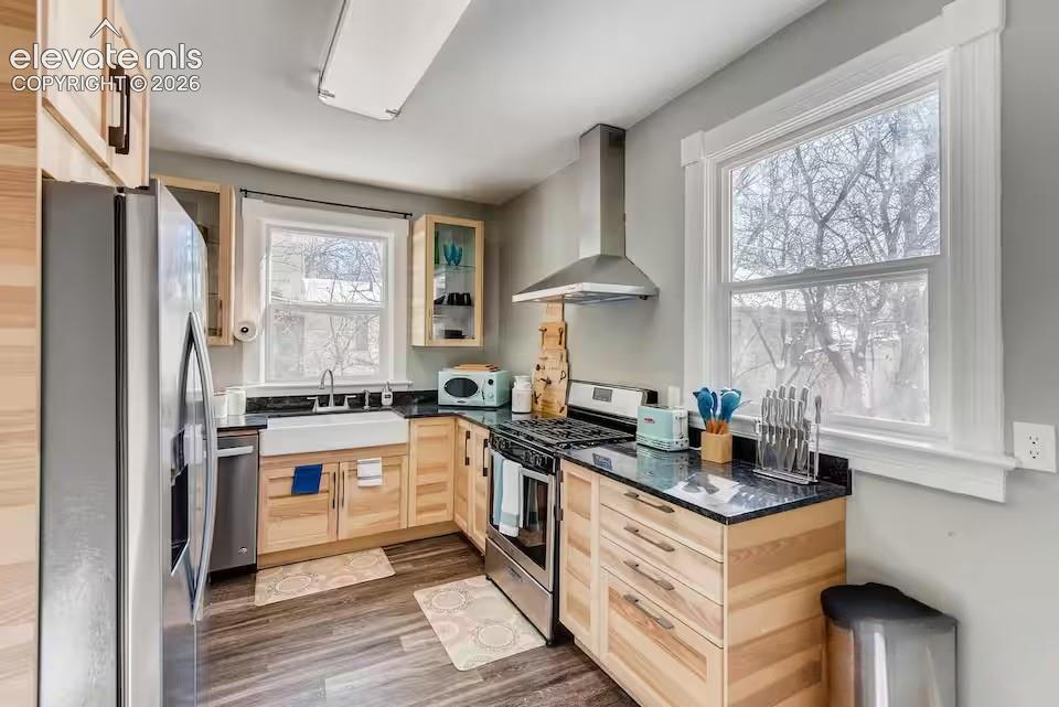 Image 4 of 27: Main floor kitchen is totally renovated with newer cabinets and granite cou