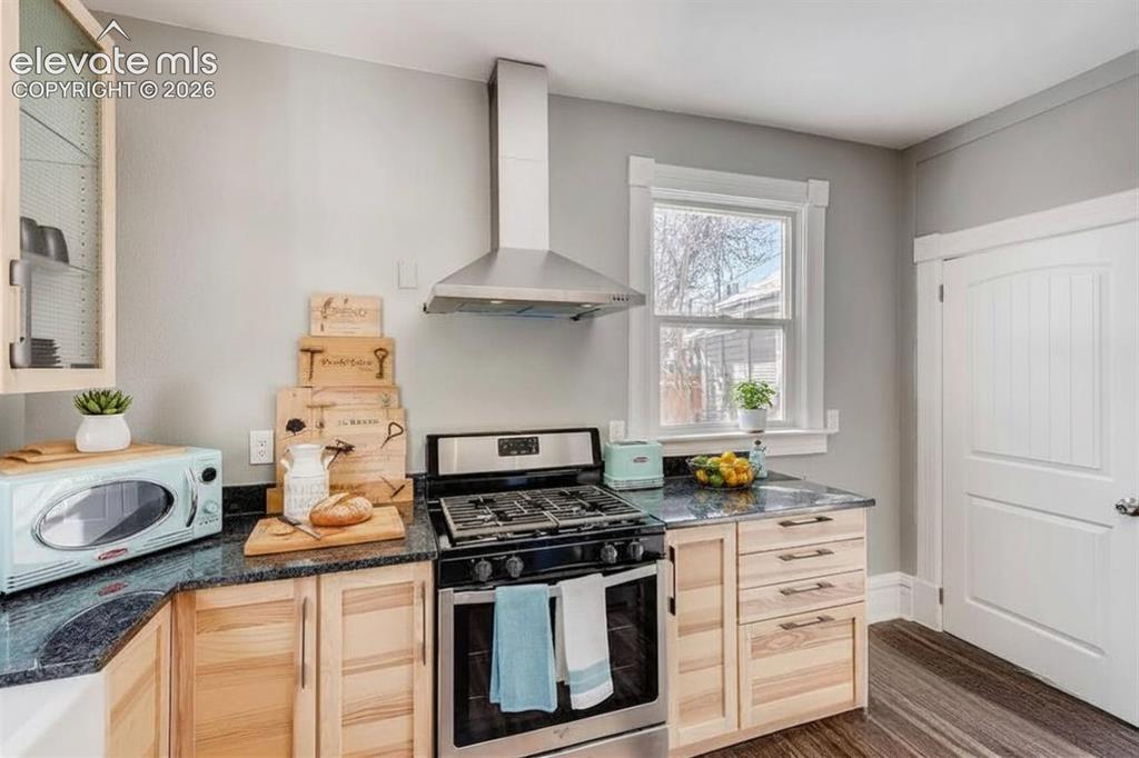 Image 5 of 27: Tons of windows and light, 1/2 bathroom and laundry room adjacent to kitche