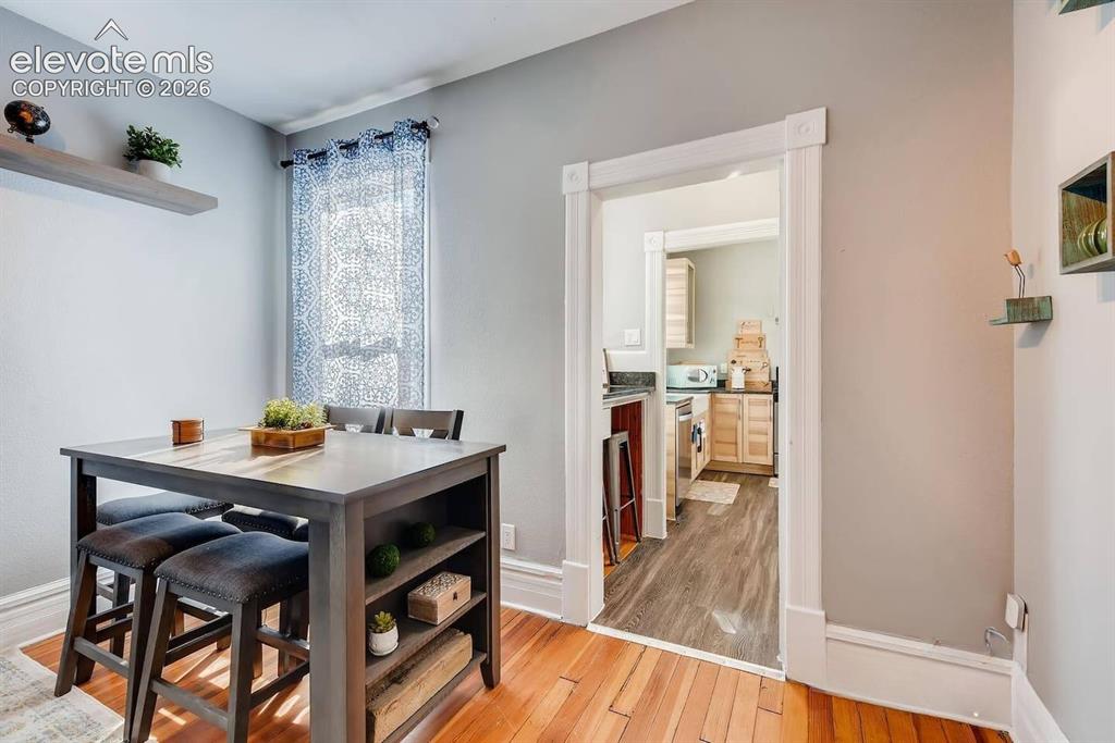Image 8 of 27: Living room offers space for sitting and dining with tall ceilings and big