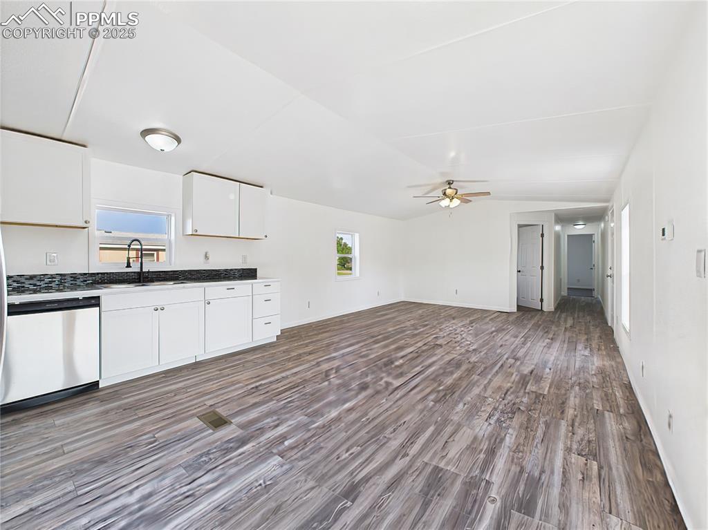 Image 16 of 49: Kitchen Toward Living Area – Full view of the kitchen opening into the livi