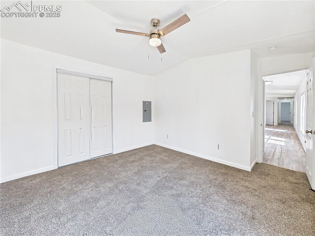 Image 22 of 49: Primary Bedroom (Alternate View) – Features double closet doors and a brigh