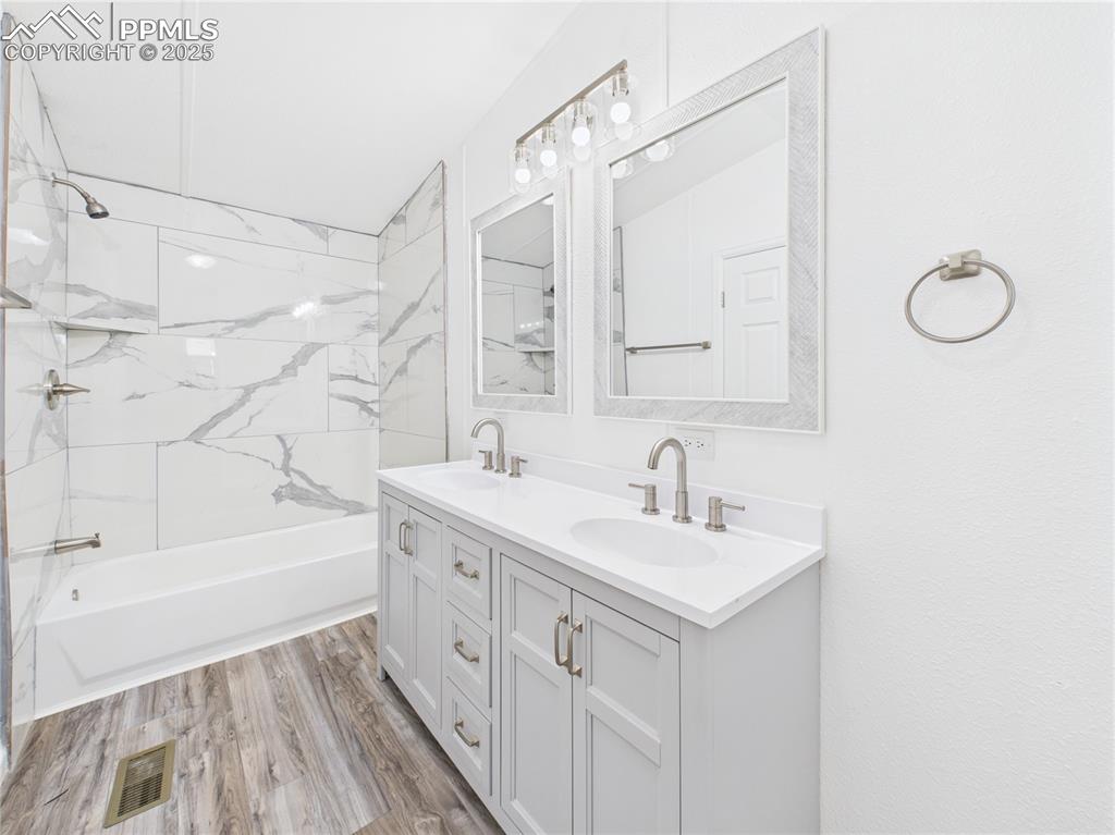 Image 24 of 49: Primary Bathroom – Stylish and spacious ensuite with dual-sink vanity, brus