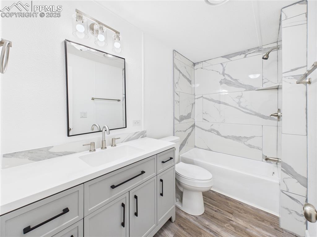 Image 35 of 49: Hall Bathroom – Updated guest bath includes vanity with matte black hardwar