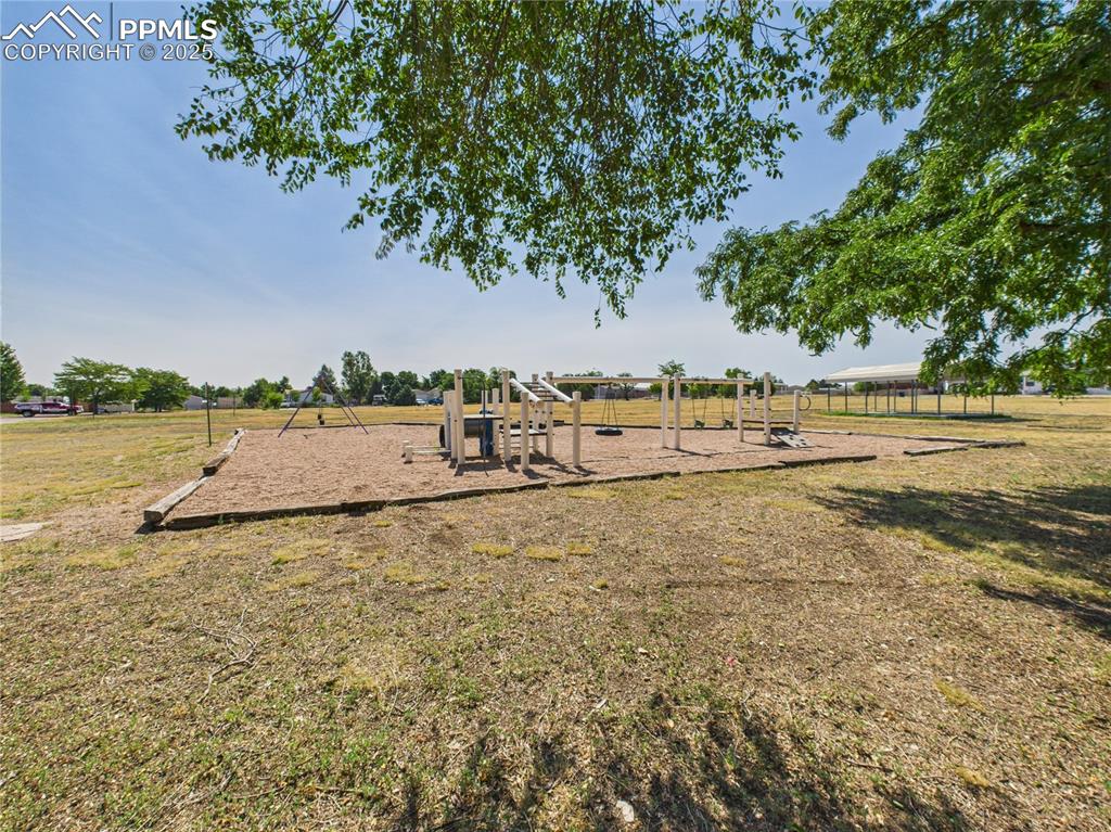 Image 48 of 49: Park Area (Alternate View) – Expansive green space with a playground and op