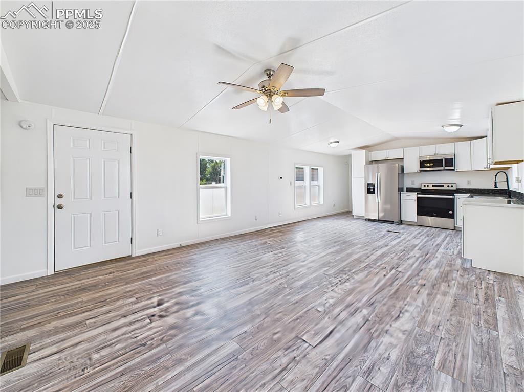 Image 5 of 49: Living Room – Freshly updated living space featuring large windows for natu