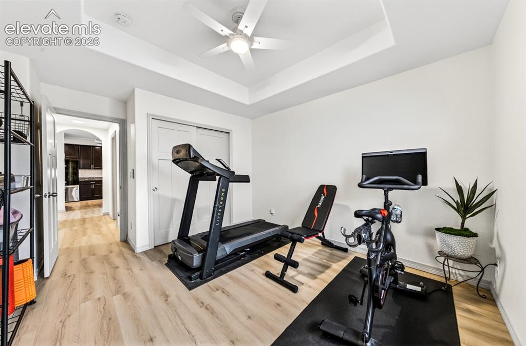 Image 10 of 50: Main level, luxury vinyl, coffered ceiling, ceiling fan