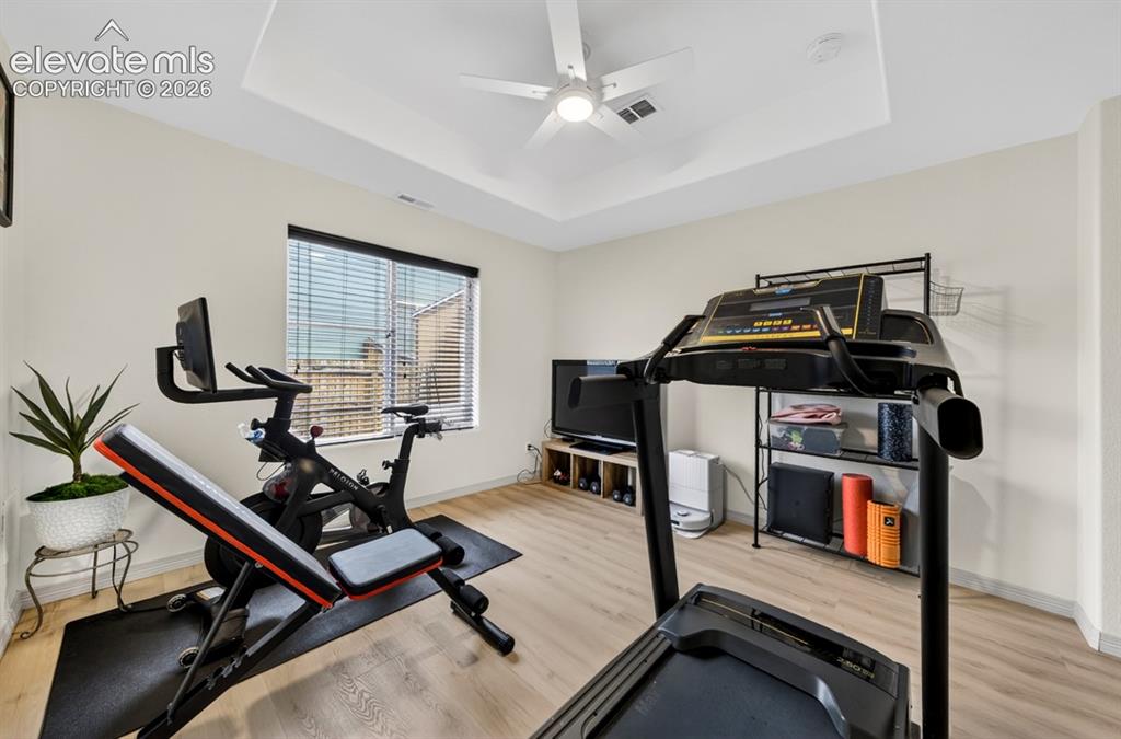 Image 11 of 50: Main level, luxury vinyl, coffered ceiling, ceiling fan