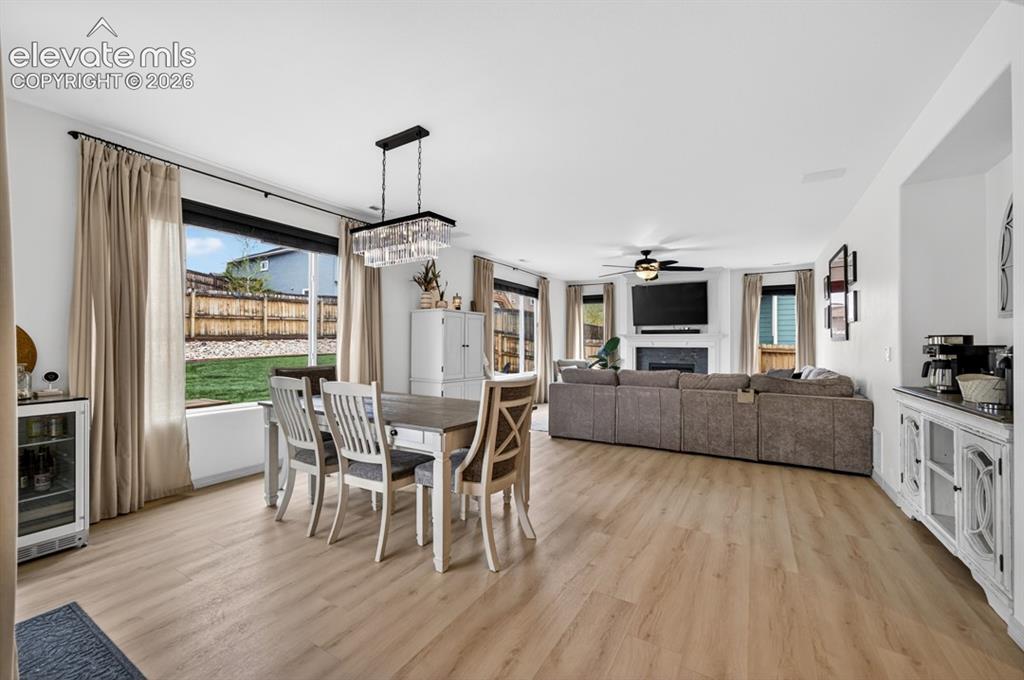 Image 19 of 50: Walk out to backyard, luxury vinyl, chandelier, large windows