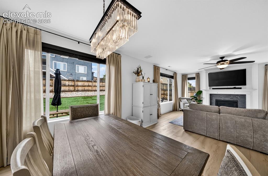 Image 20 of 50: Walk out to backyard, luxury vinyl, chandelier, large windows