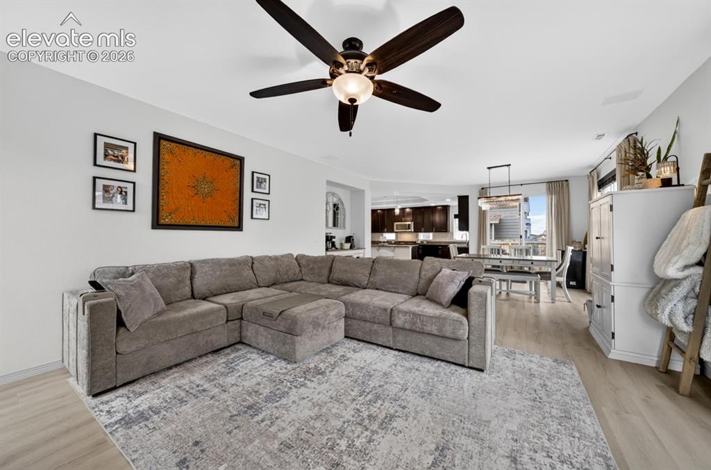 Image 23 of 50: Gas fireplace, large windows, ceiling fan, luxury vinyl, surround sound spe