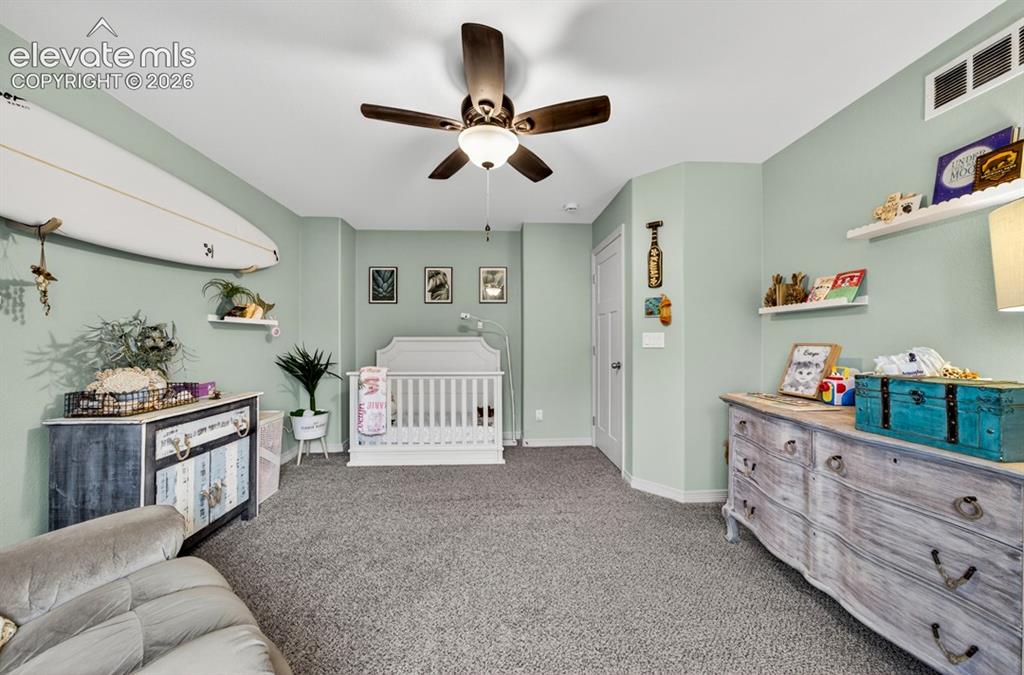 Image 35 of 50: Upper level, new carpet, ceiling fan, walk-in closet