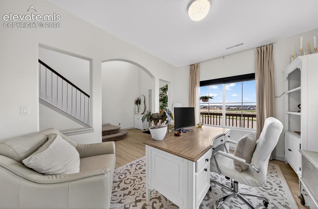 Image 7 of 50: Luxury vinyl, large windows, view of front, main level