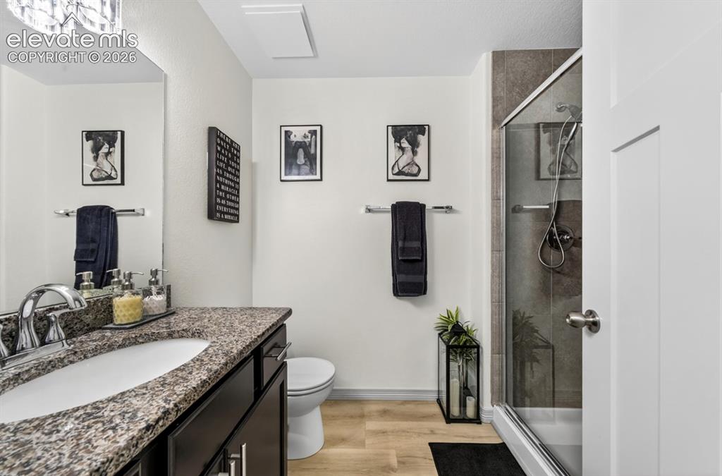 Image 8 of 50: Main level, granite, tile shower w/ built-in bench