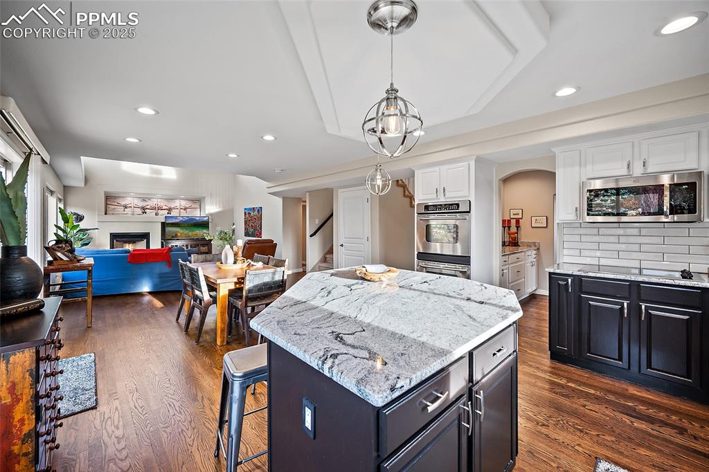 Image 12 of 50: Kitchen opens up to dining space and living room.