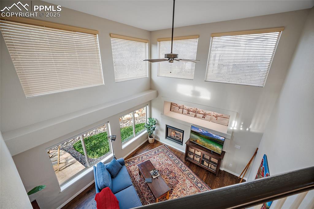 Image 19 of 50: Living area with a high ceiling, healthy amount of natural light, a firepla