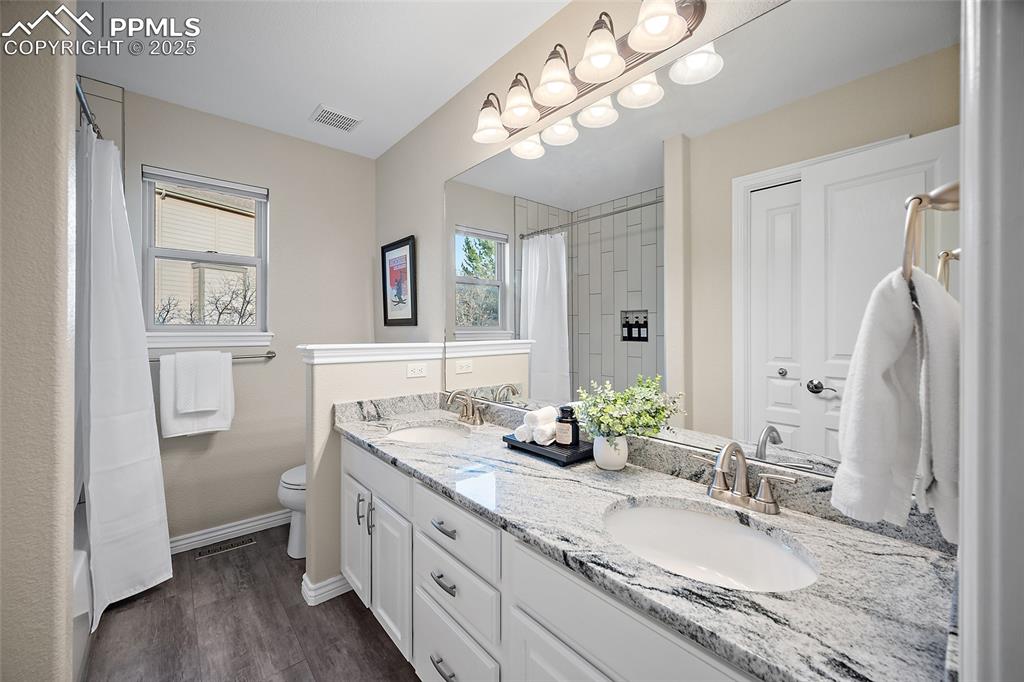 Image 31 of 50: Upper level full bath with luxury vinyl tile flooring, granite countertops 