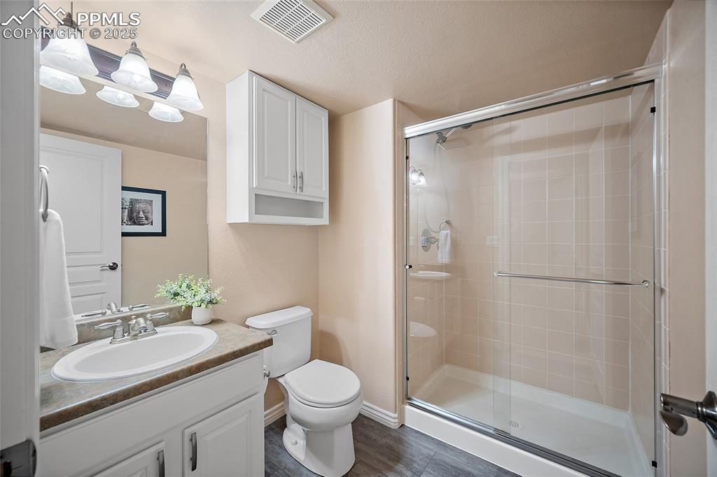 Image 41 of 50: Lower level 3/4 bathroom with luxury vinyl tile flooring.