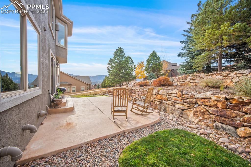 Image 43 of 50: View of patio with a mountain view