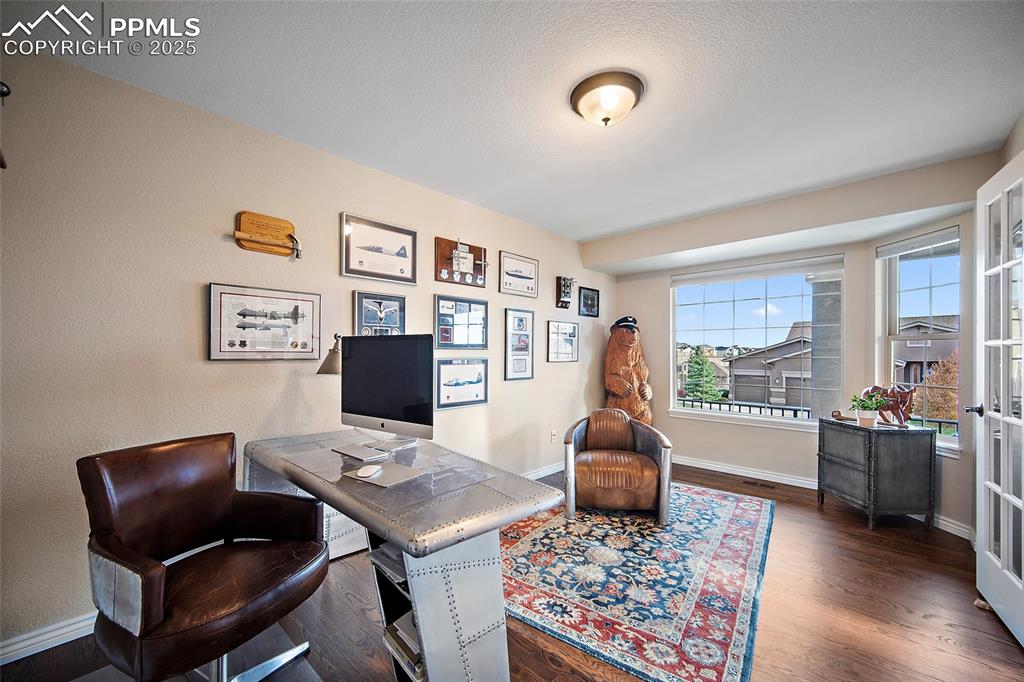 Image 5 of 50: Office space featuring dark wood flooring.
