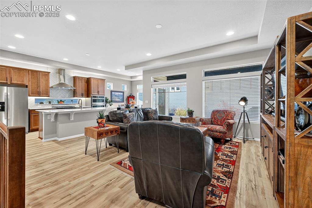 Image 10 of 43: Living area featuring light wood-style floors and recessed lighting