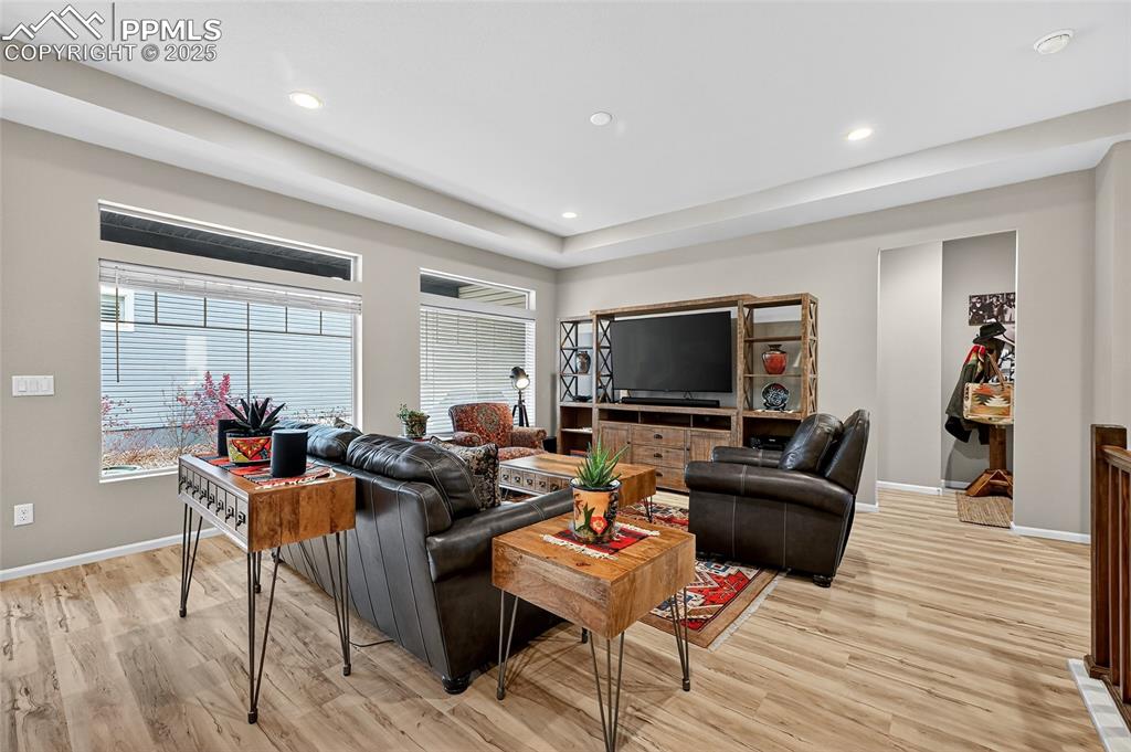 Image 11 of 43: Living area with light wood finished floors, plenty of natural light, and r