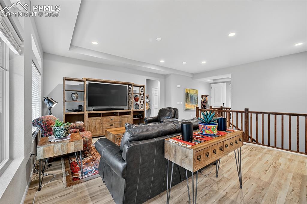 Image 12 of 43: Living room with recessed lighting and light wood-style flooring