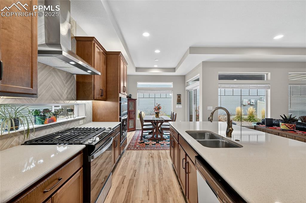 Image 16 of 43: Kitchen featuring range with gas stovetop, light wood-type flooring, light