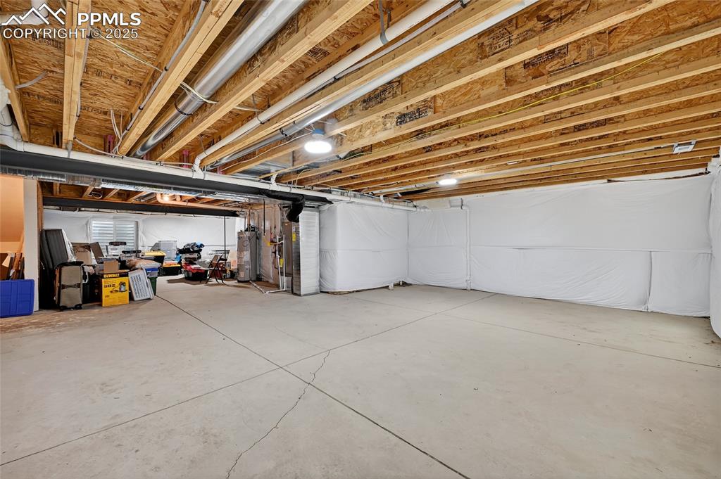 Image 27 of 43: Unfinished below grade area with gas water heater