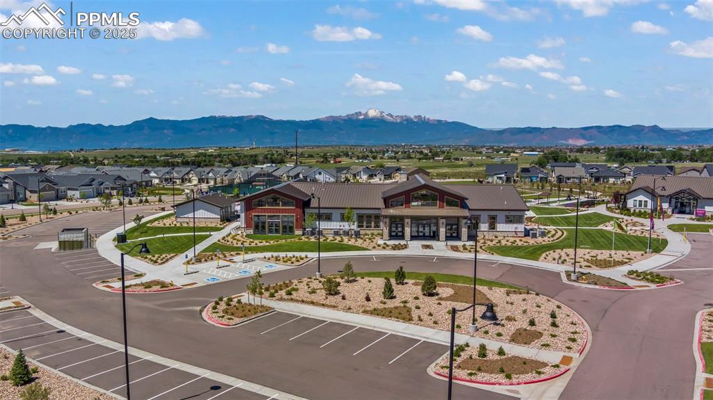 Image 33 of 43: Aerial view of residential area featuring a mountain backdrop