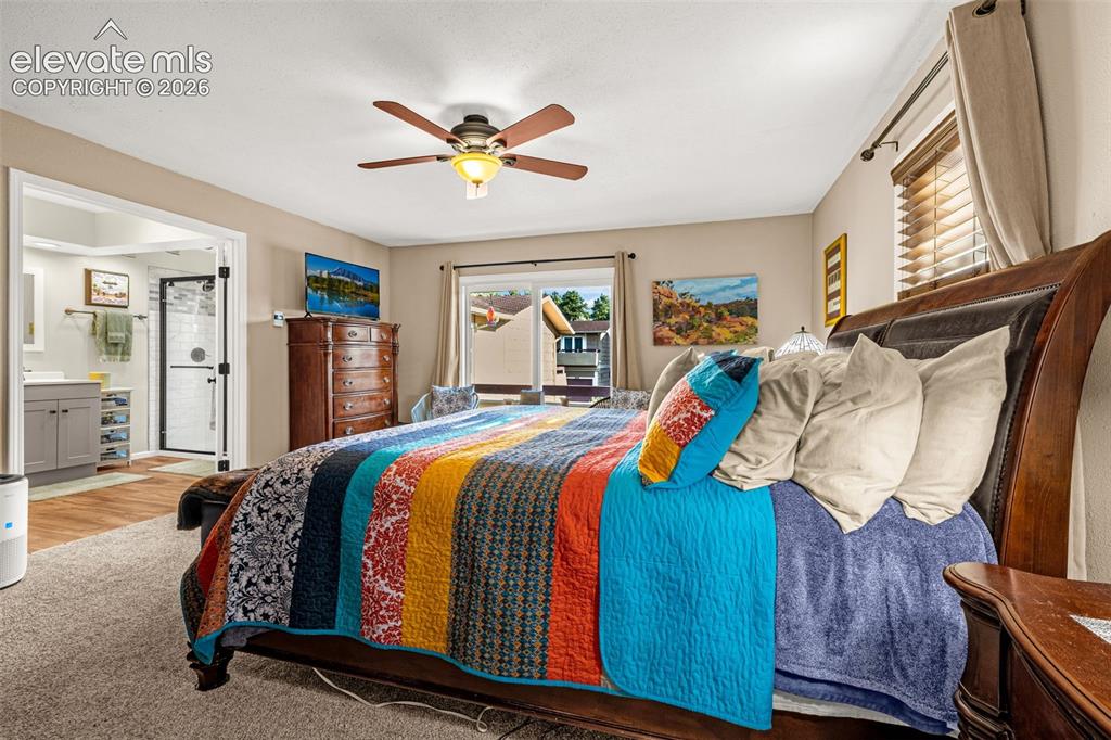 Image 13 of 21: Bedroom has sliding glass doors to private balcony offering light as well a