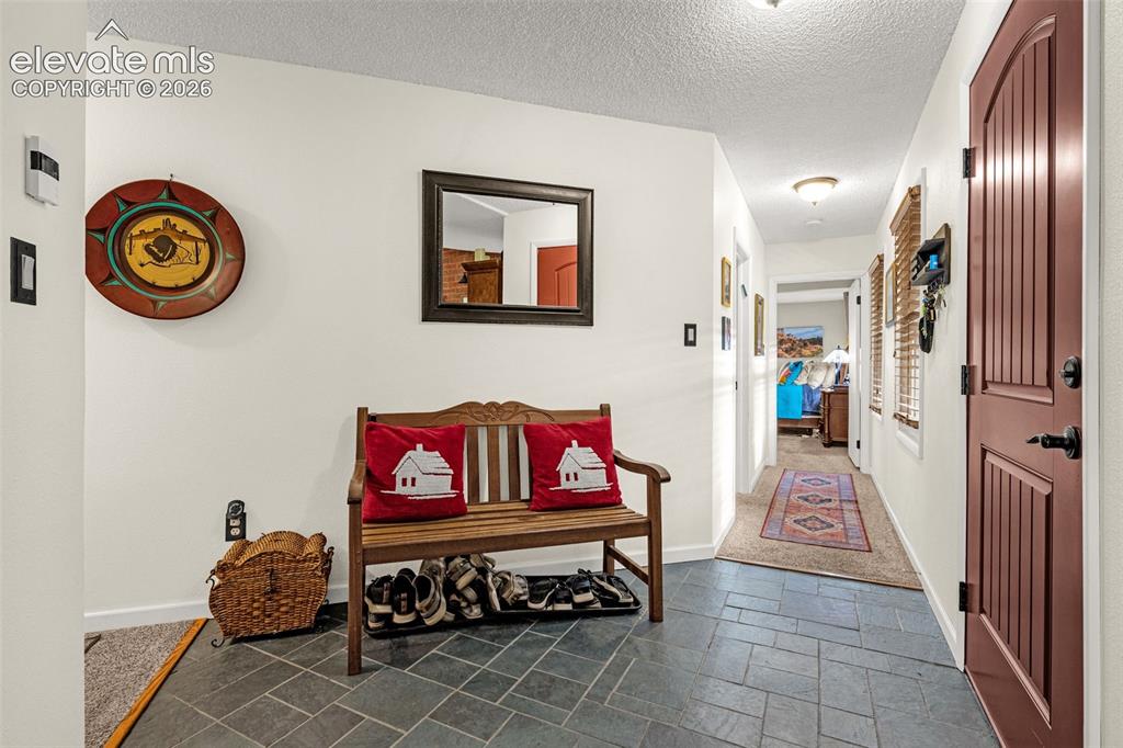 Image 4 of 21: Welcoming entry foyer with tile flooring and double closet