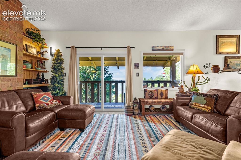 Image 7 of 21: Family room walks out to large covered patio with lake views