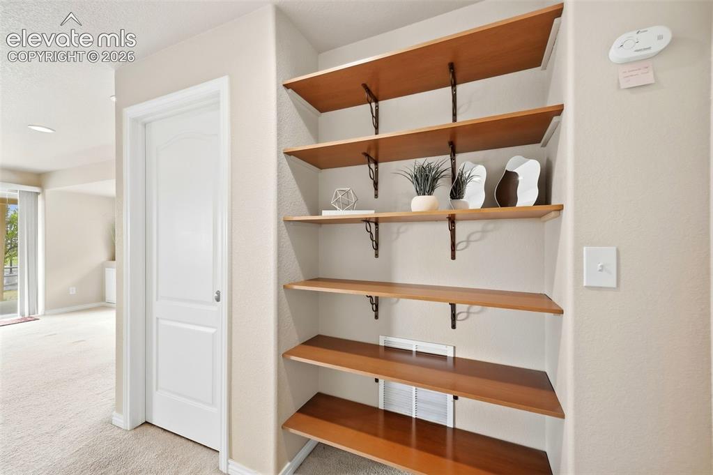 Image 17 of 40: Built in shelving in basement hall