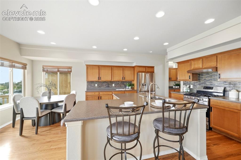 Image 7 of 40: Eat in Kitchen with SS appliances, butlers pantry and hard wood flooring