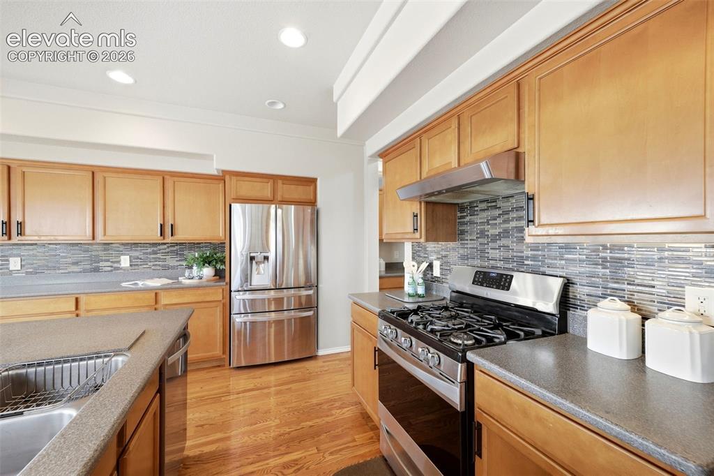 Image 8 of 40: Eat in Kitchen with SS appliances, butlers pantry and hard wood flooring