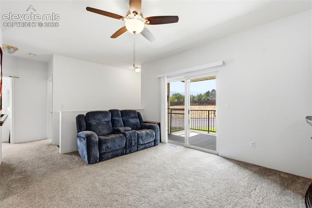 Image 11 of 25: Carpeted living space with a ceiling fan and recessed lighting