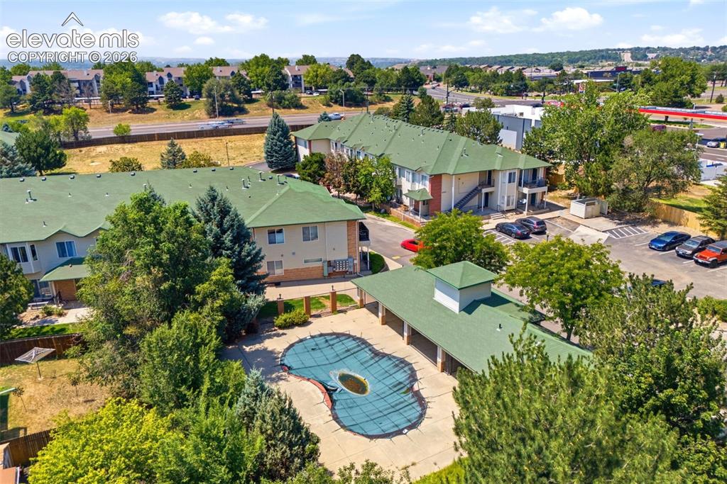 Image 23 of 25: Community featuring multiple buildings with green roofs, ample parking, mat