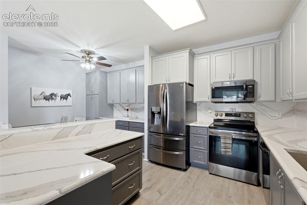 Image 6 of 25: Kitchen featuring stainless steel appliances, light wood-finish flooring, t